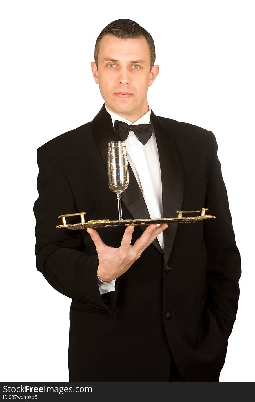 The imposing man in a classical tuxedo with a wine glass on a tray