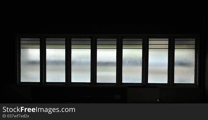 Windows in silhouette showing leakage of light.