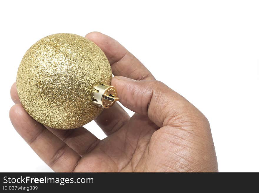 Hand holding a beautiful golden Christmas ball