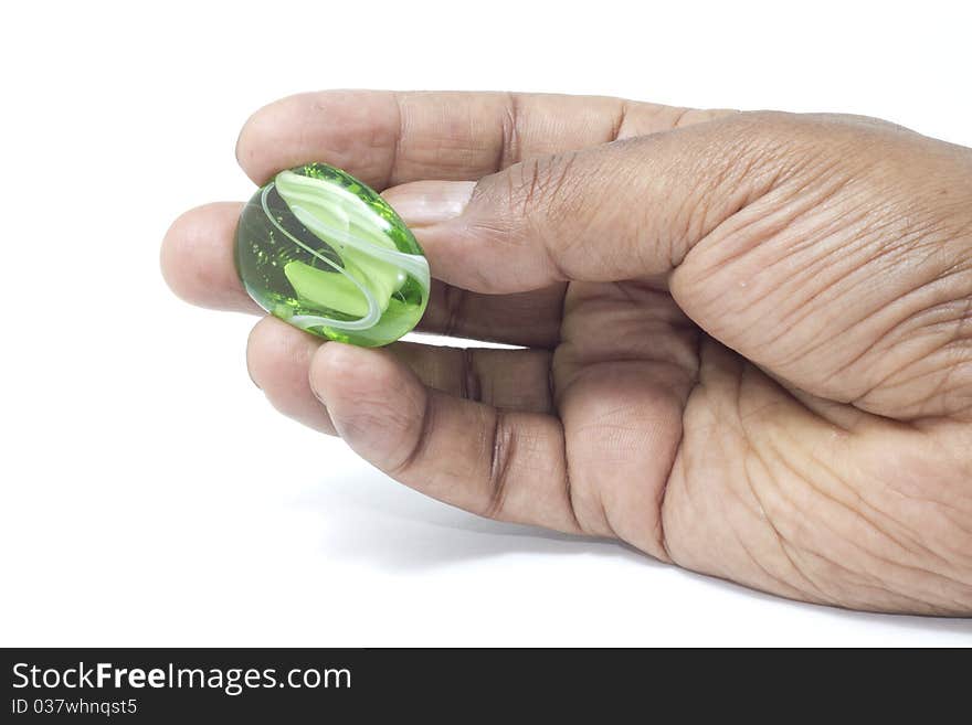 Hand holding a beautiful green marble