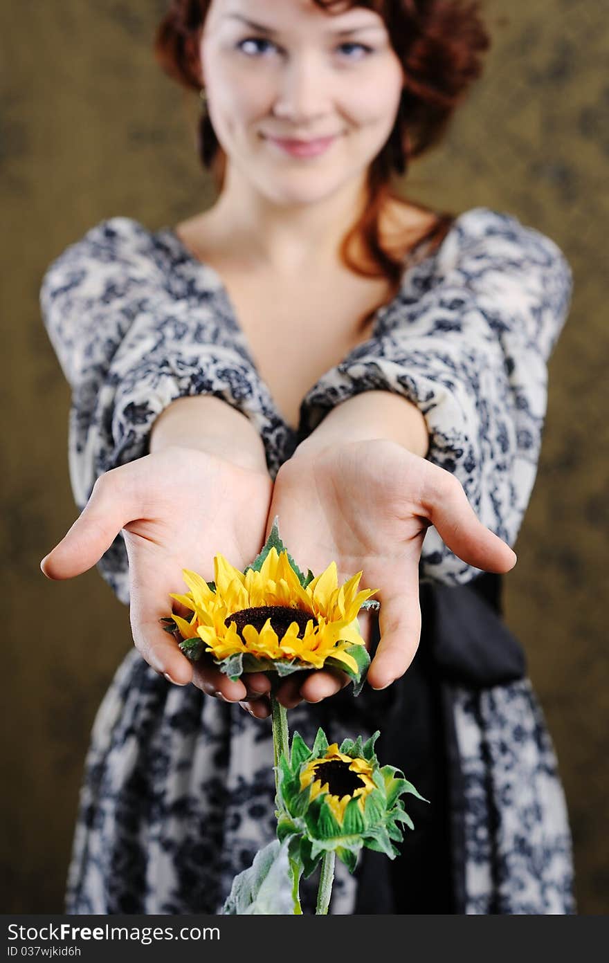 An image of young woman with yellow flower. An image of young woman with yellow flower