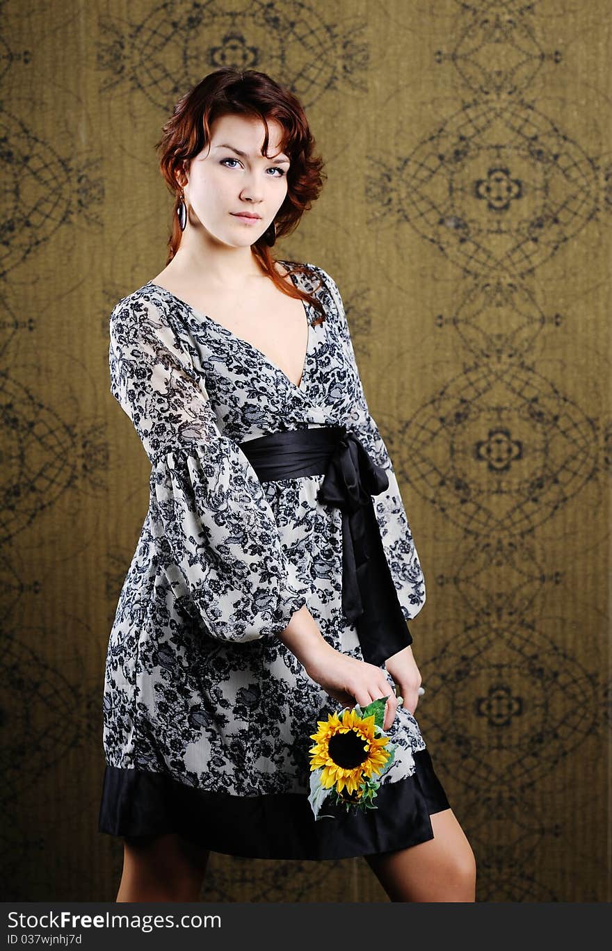 An image of young woman with sunflower