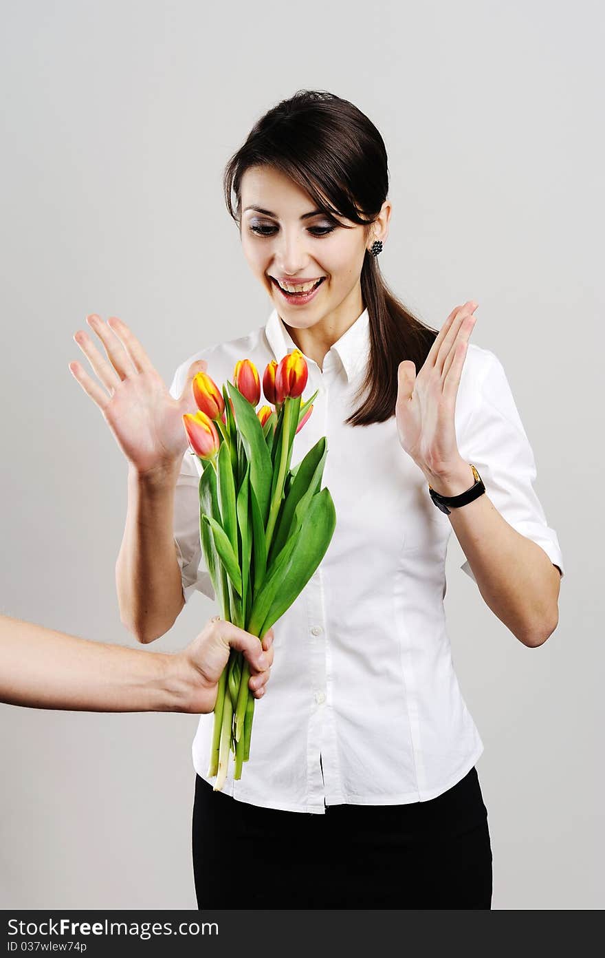 An image of a woman given a bunch of flowers. An image of a woman given a bunch of flowers