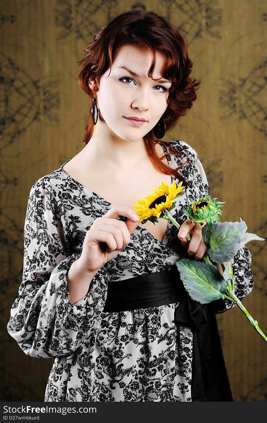 An image of young woman with sunflower