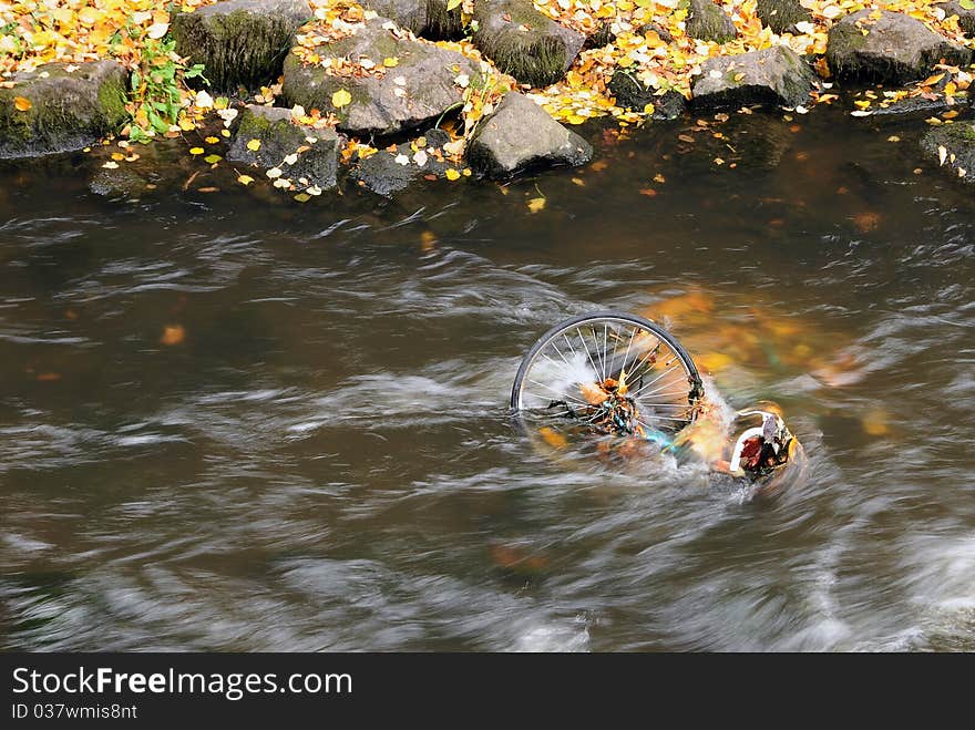 A bicycle thrown away into a streem submerged under water. A bicycle thrown away into a streem submerged under water