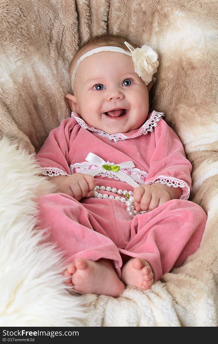 Smiling baby on a beautiful beige background