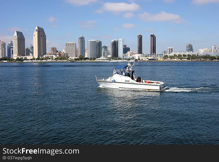 San Diego skyline and a patrol boat.