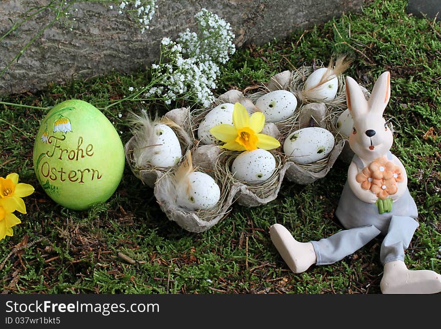 Easter bunny and easter eggs in the garden