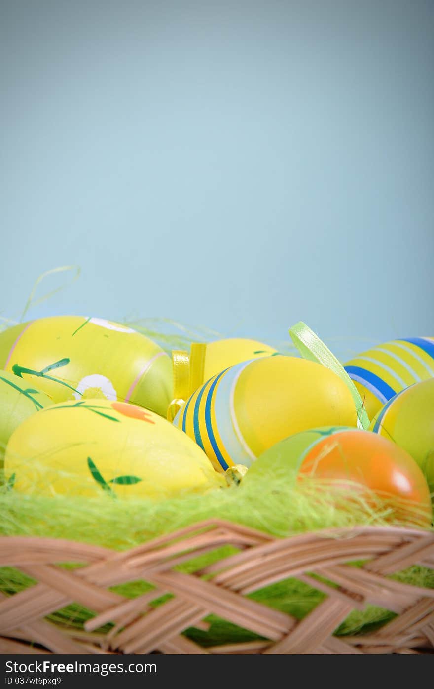 Colorful Easter Eggs basket set on blue background