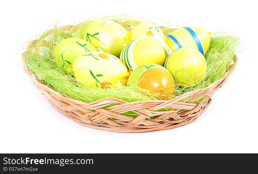 Easter basket with painted eggs on white background