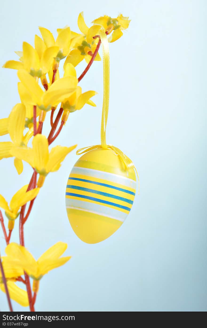 Hand-painted Easter egg on forsythia branches