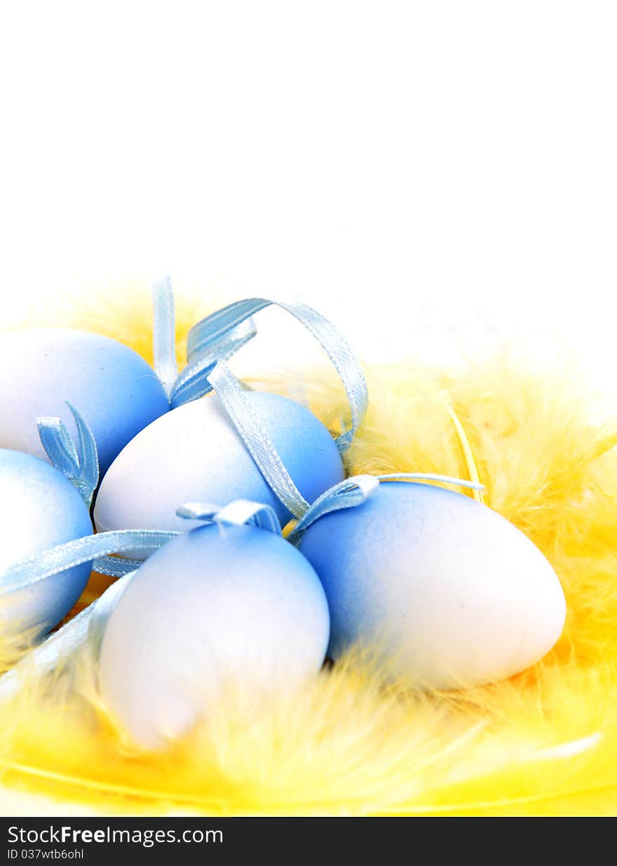 Easter eggs on yellow feathers