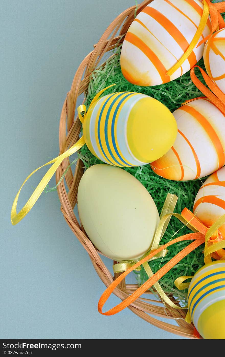 Colorful Easter Eggs basket set on blue background