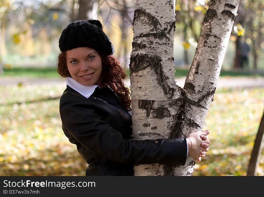 Curly beautiful smiling girl in autumn park. Curly beautiful smiling girl in autumn park