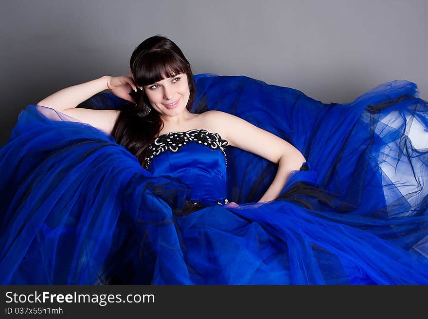 The girl in a dark blue evening ball dress. The girl in a dark blue evening ball dress