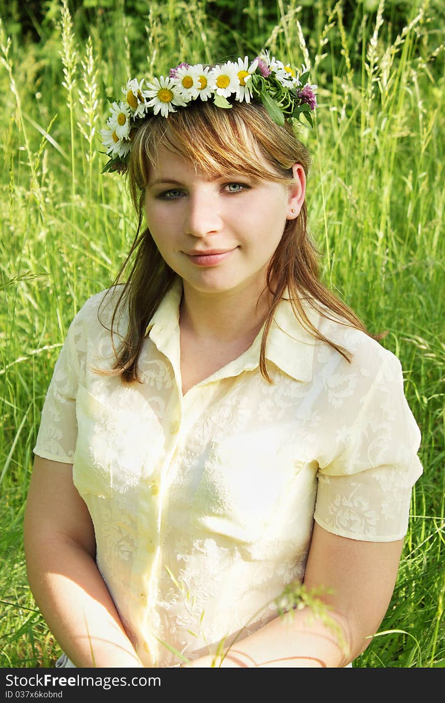 The portrait of young girl into the wreaths