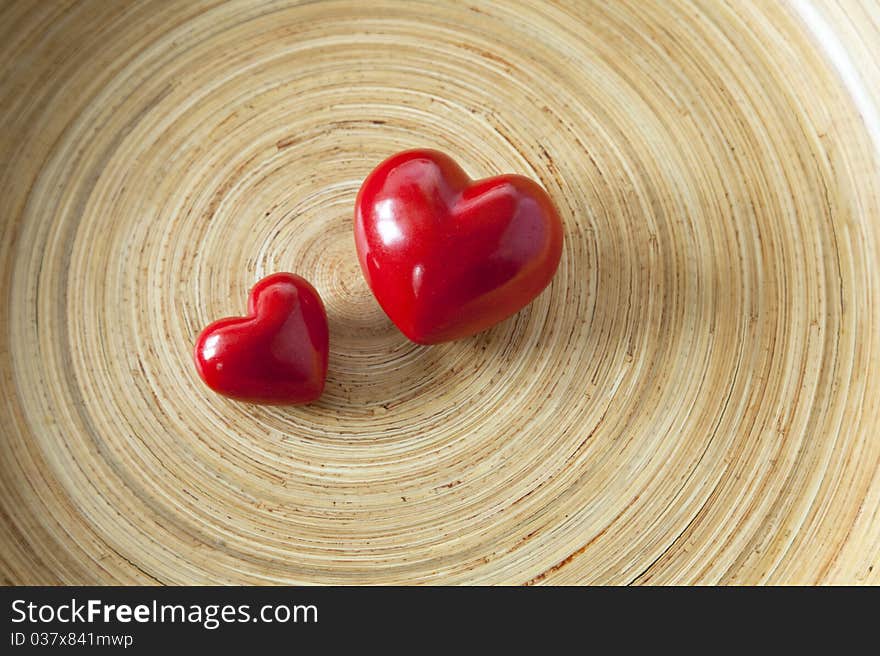 Two red hearts lie in a shell of wood