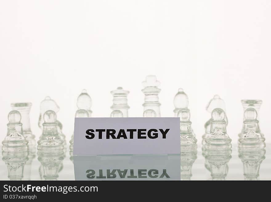 Beautiful glass chess on a white background. Photo taken in the studio on a glass countertop. Beautiful glass chess on a white background. Photo taken in the studio on a glass countertop.