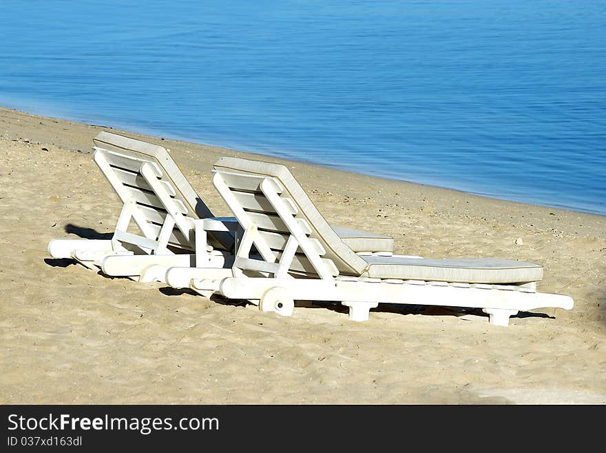 Two sundecks on the beach, facing the sea