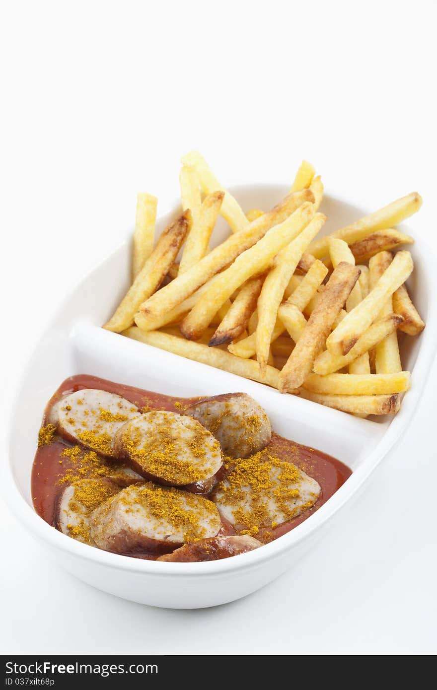 Curried sausages and french fries on a plate