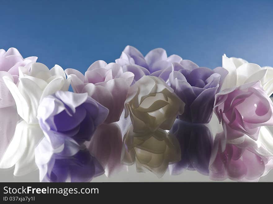 3 different color of flower soaps on the mirror