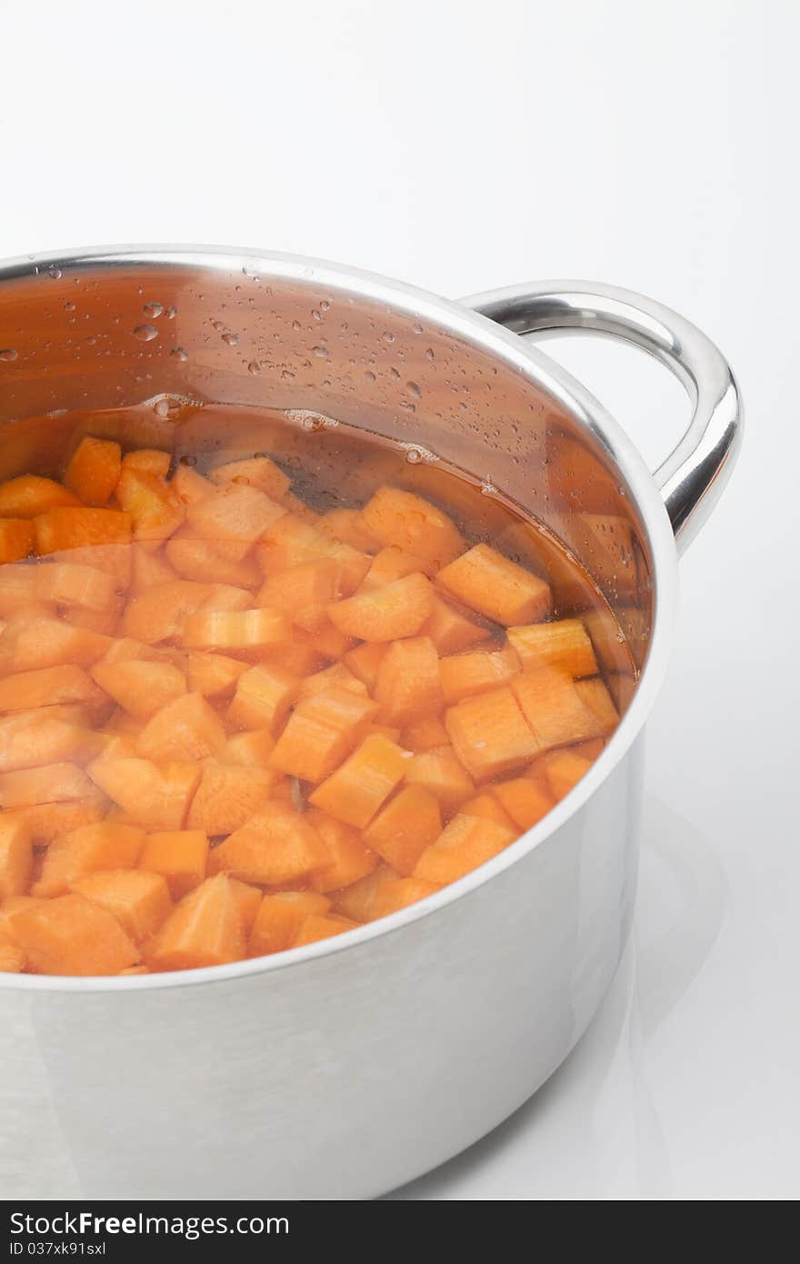 Peaces of carrots in a cooking pot. Peaces of carrots in a cooking pot