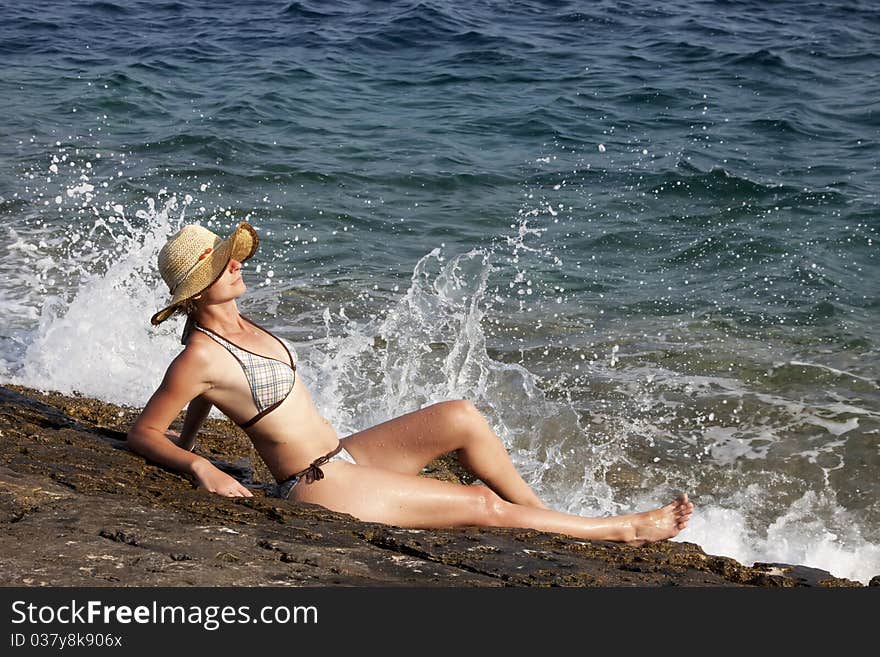 Woman with hat sunbathing