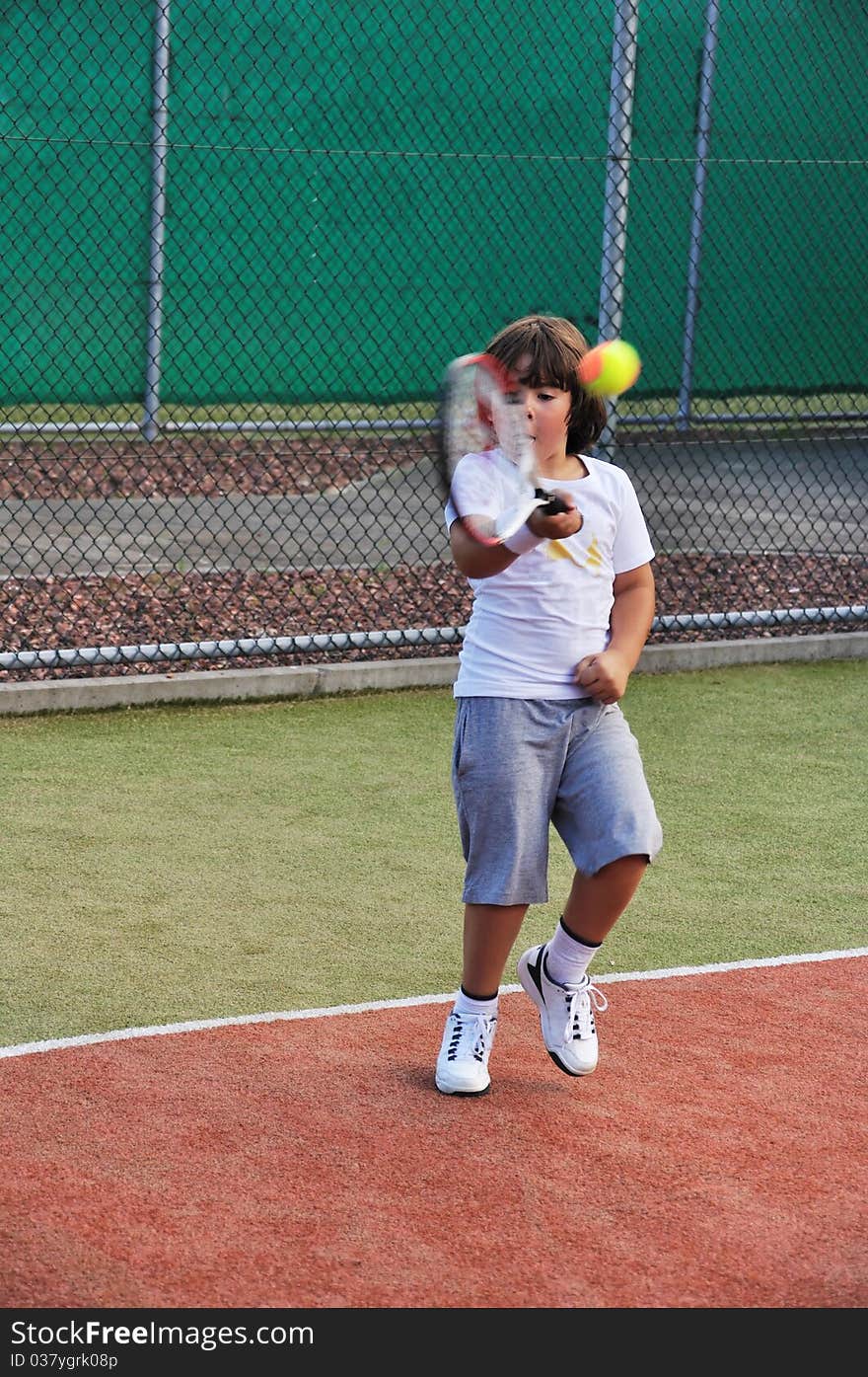 Young boy play tennis outdoor