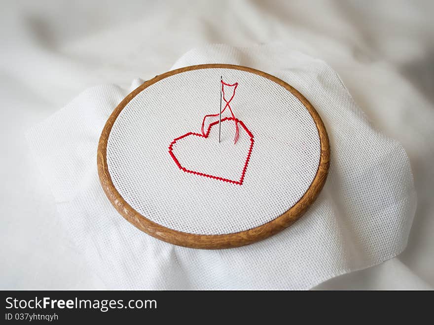 Embroidered red heart on tambour. Embroidered red heart on tambour