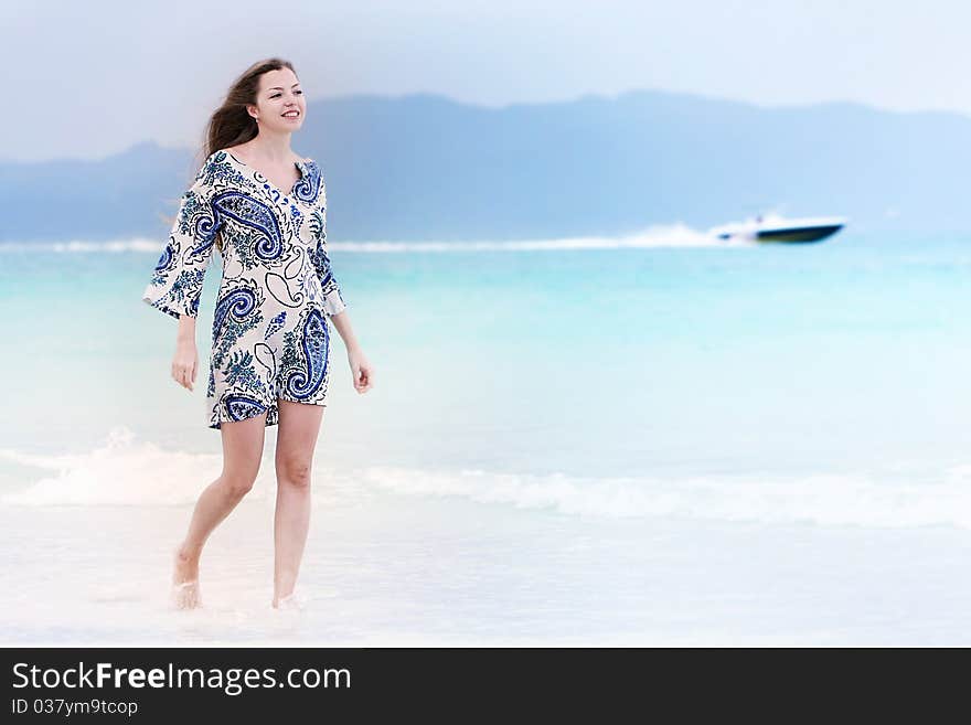 Young woman walking on beach