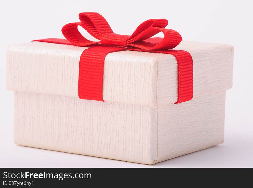 White gift box with red ribbon