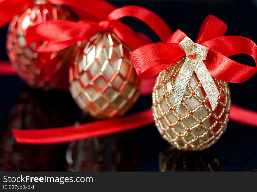 Eggs decorated with beads over the black background. Eggs decorated with beads over the black background