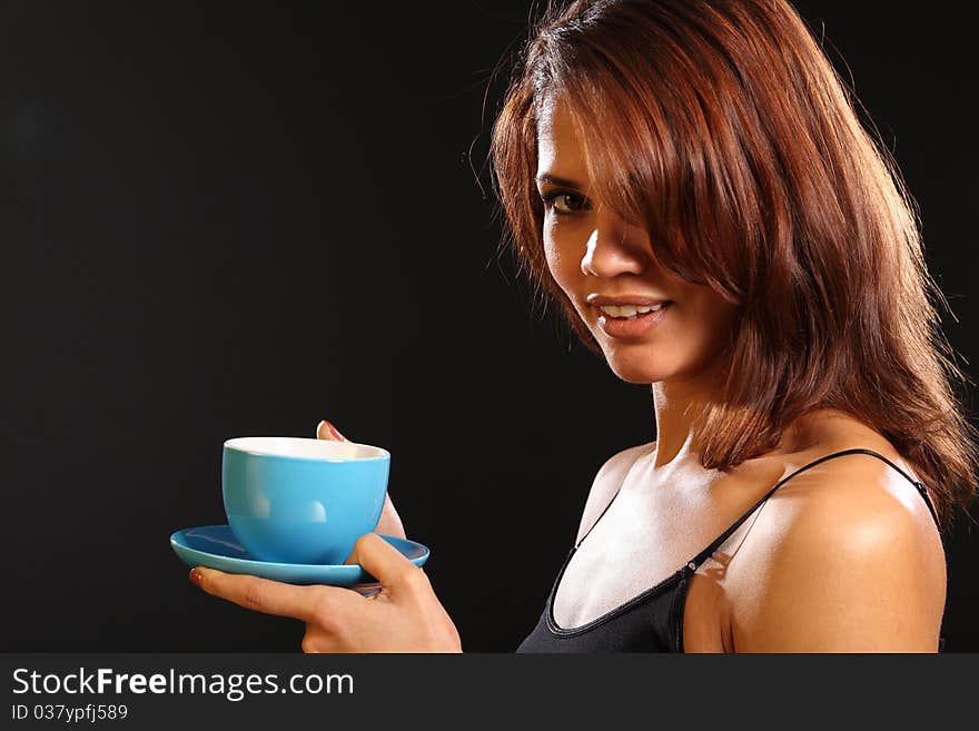 Young Ethnic Woman Holding Hot Drink In Blue Cup