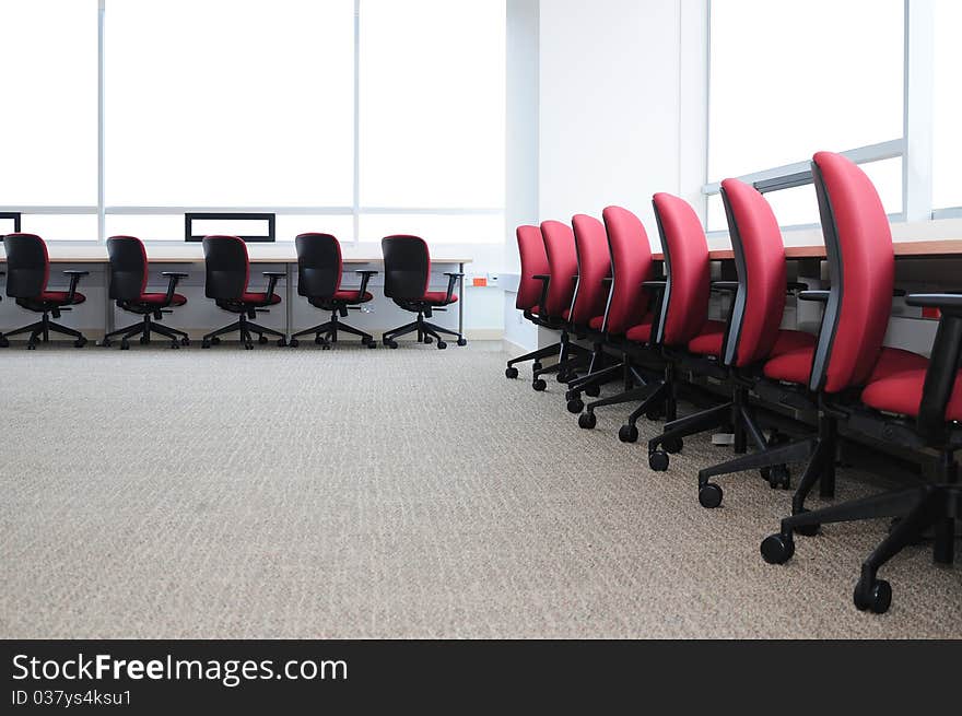 Empty desk with row of seats in a library. Empty desk with row of seats in a library.