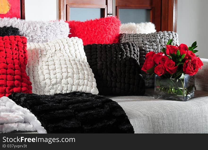 Stack of soft cushions with flowers on couch. Stack of soft cushions with flowers on couch.