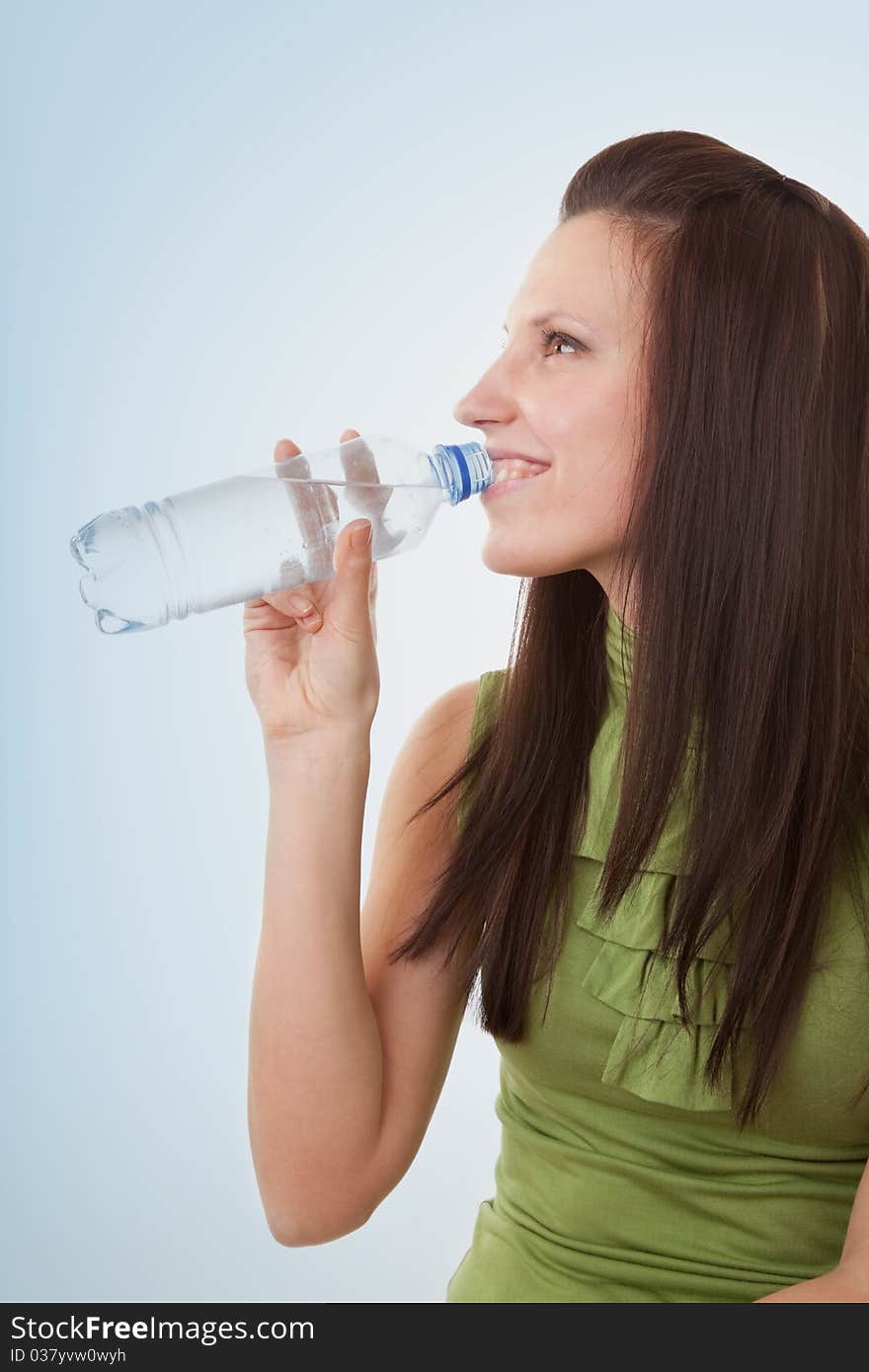 Young woman drinking bottled mineral water. Young woman drinking bottled mineral water