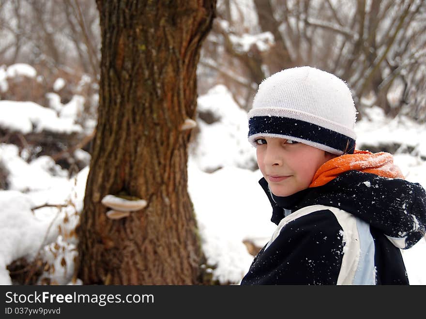 Teenage smiling caucasian boy outdoor over winter snowy background. Teenage smiling caucasian boy outdoor over winter snowy background