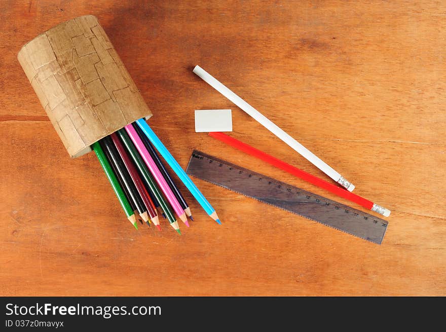 Variety of color pencils on wooden desk. Variety of color pencils on wooden desk.