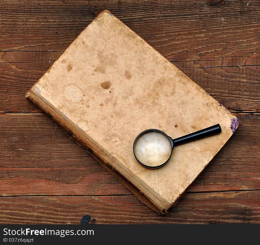 Old book cover on wood background