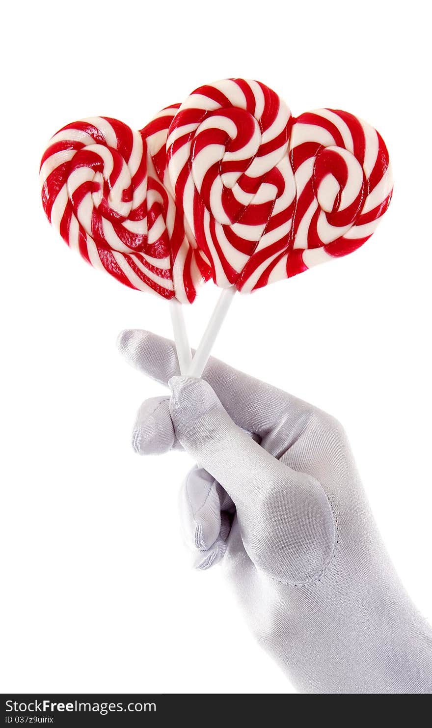 Hand holding candy in the shape of a heart