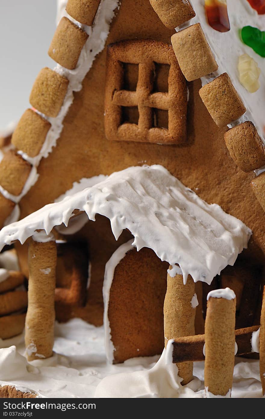 Fragment of gingerbread house entrance with the door open under the canopy. Fragment of gingerbread house entrance with the door open under the canopy