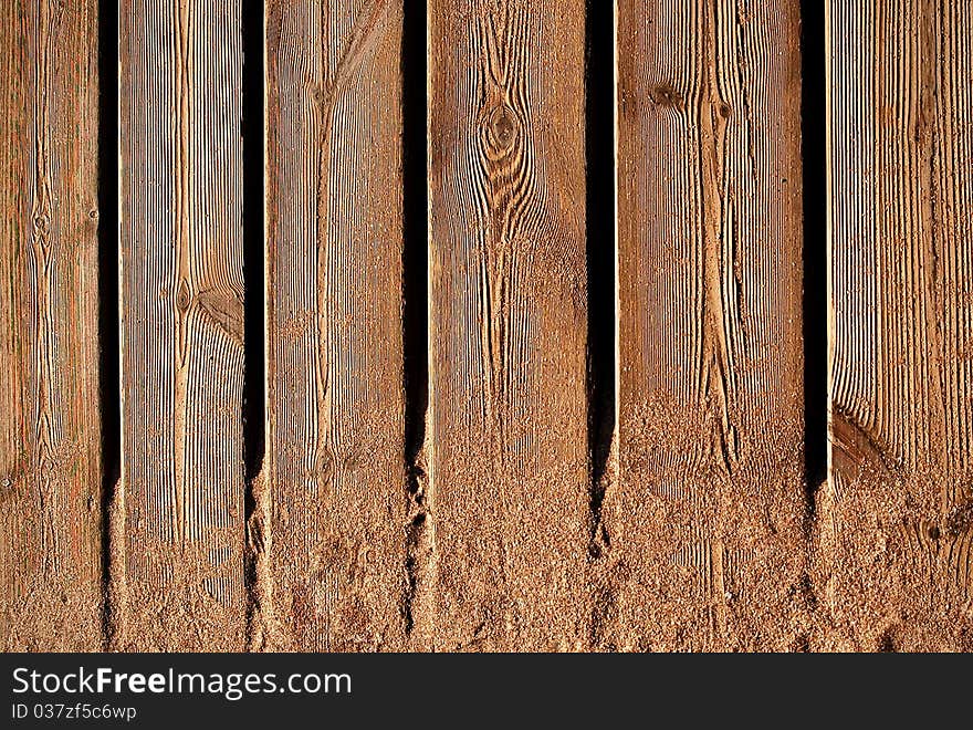 Woody planks whit sand of the beach