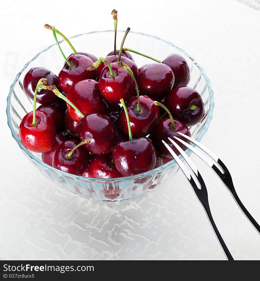 A bowl of fresh cherry with two fruit fork for couple. A bowl of fresh cherry with two fruit fork for couple.