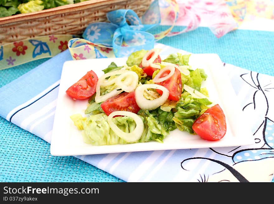 A fresh salad with tomatoes on a plate