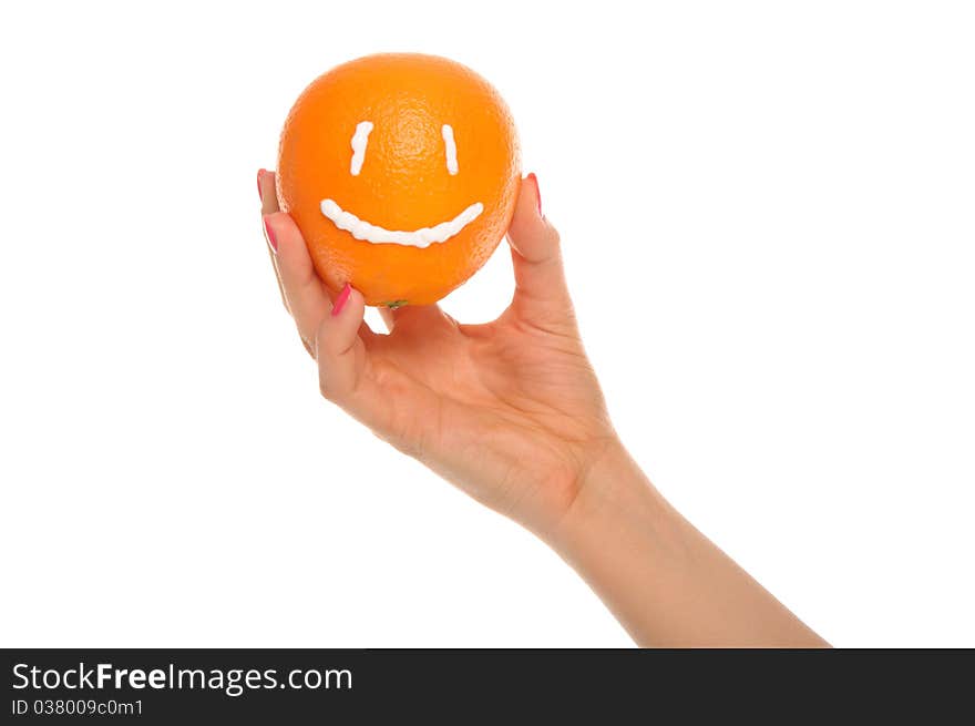 Hand holds orange with drawn smile isolated in white