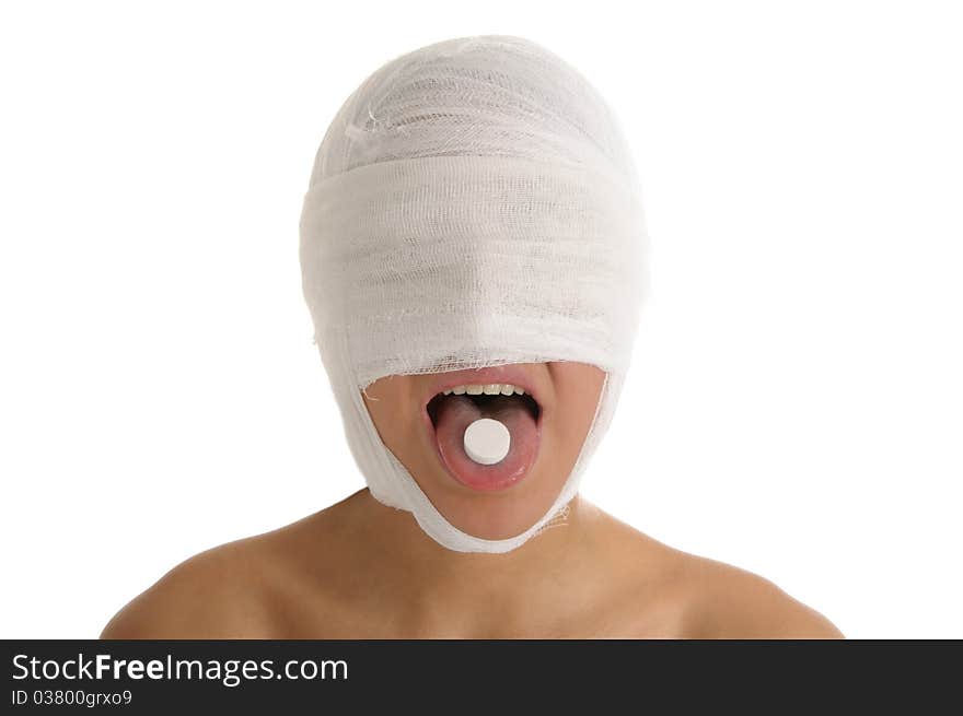 Young woman with bandaged head with tablet in tongue isolated in white