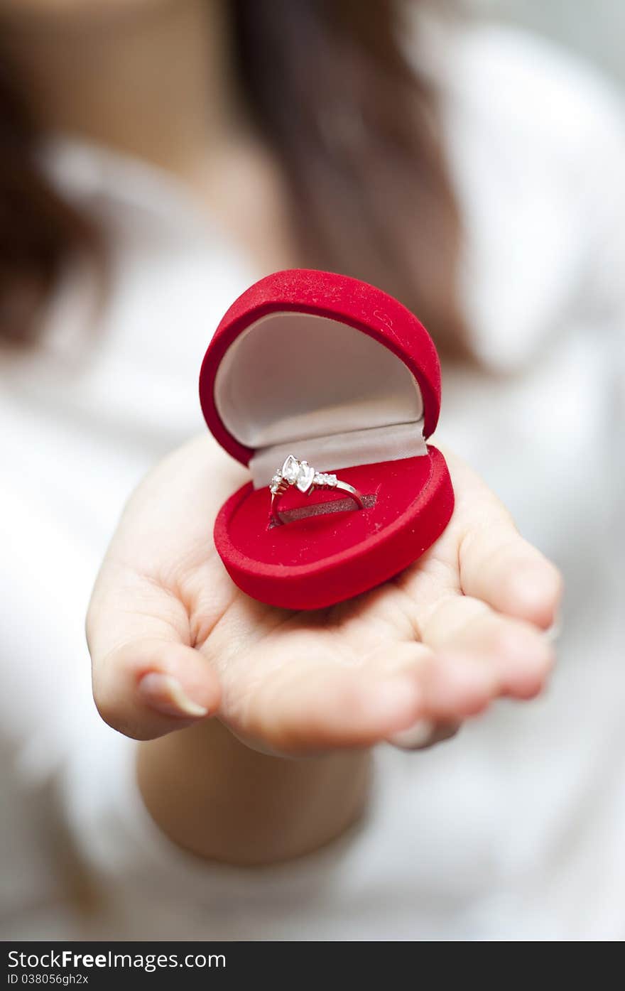 Red box with engagement ring inside