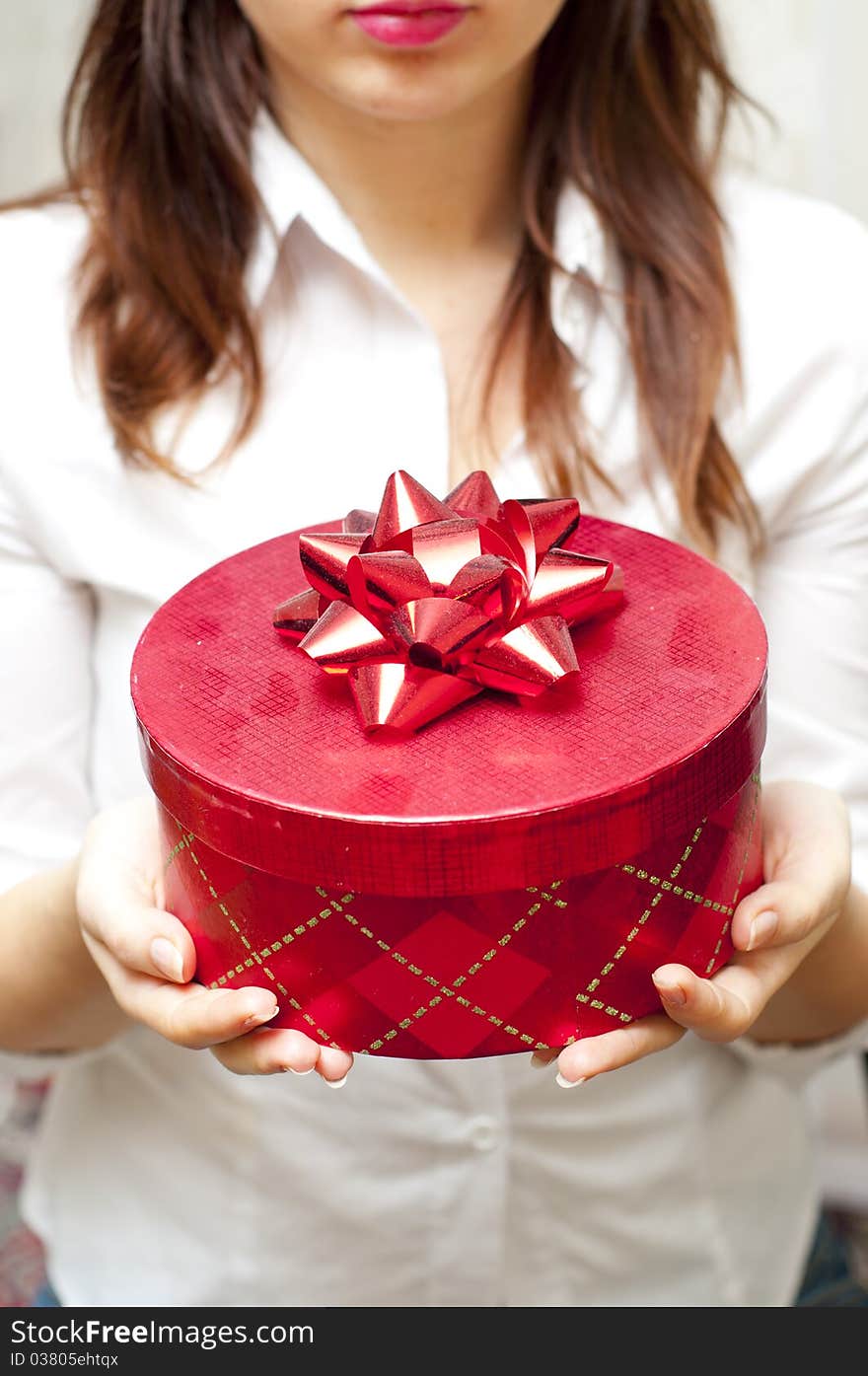 Red box holding in hand of young girl