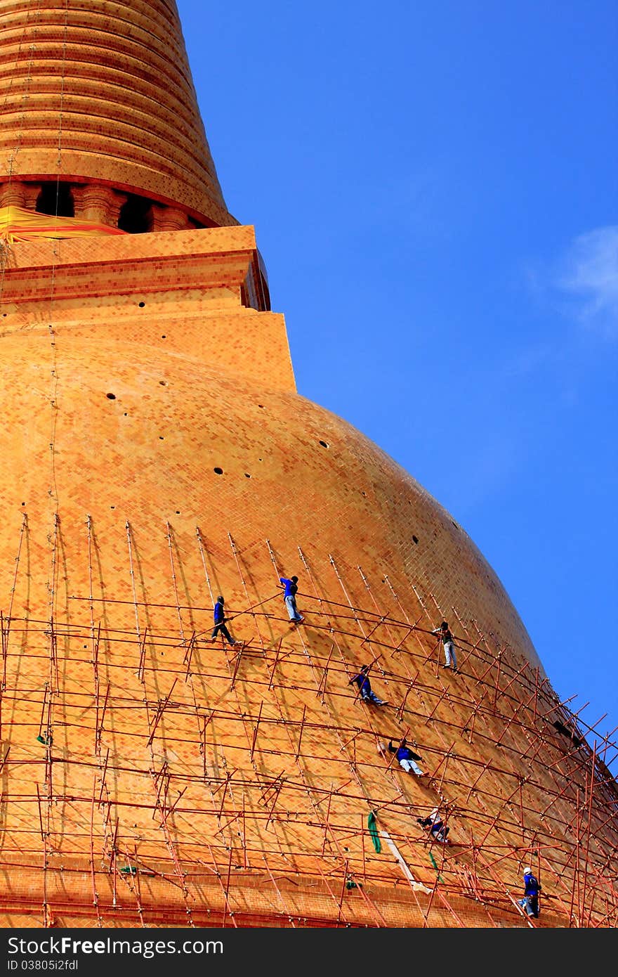 Workers on iron scaffold to repair a pagoda at the temple, Thailand. Workers on iron scaffold to repair a pagoda at the temple, Thailand