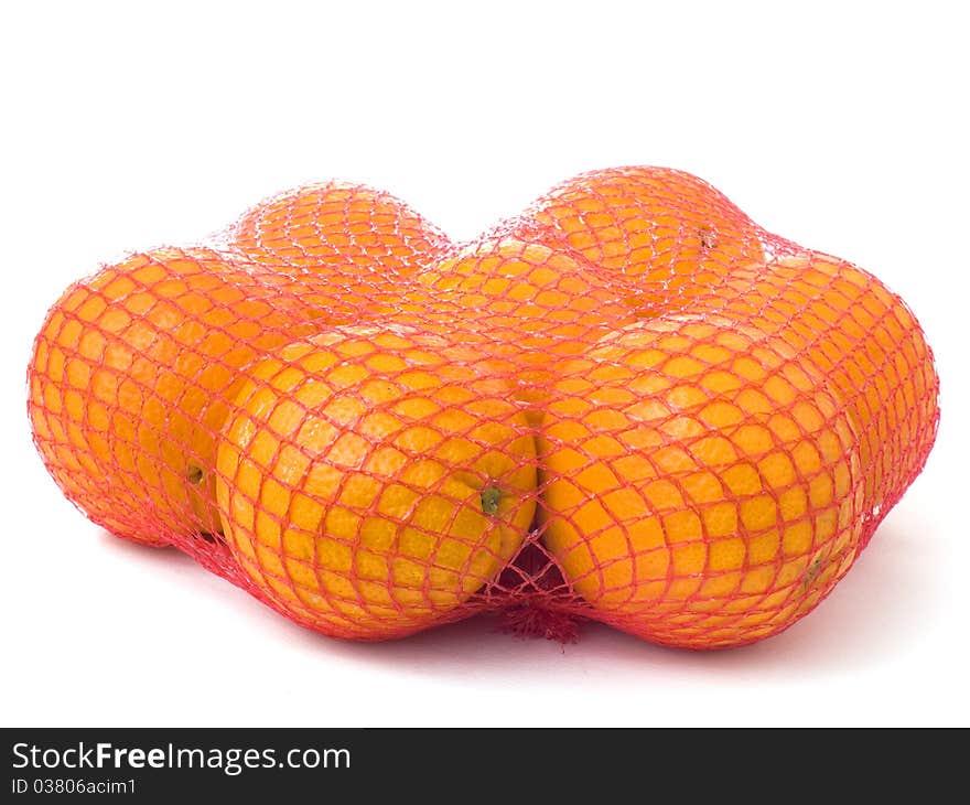 Seven oranges in a red net isolated on white background